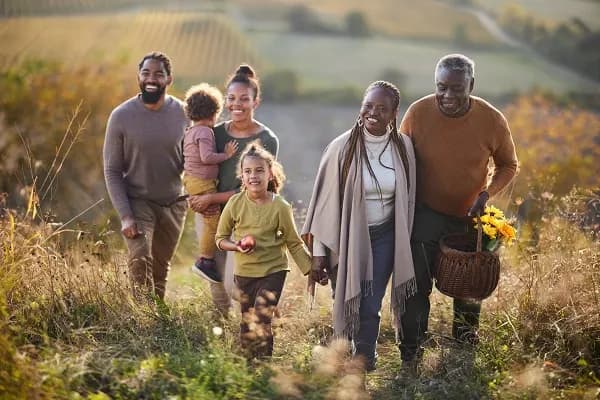 Multi-generational family walking together in a field